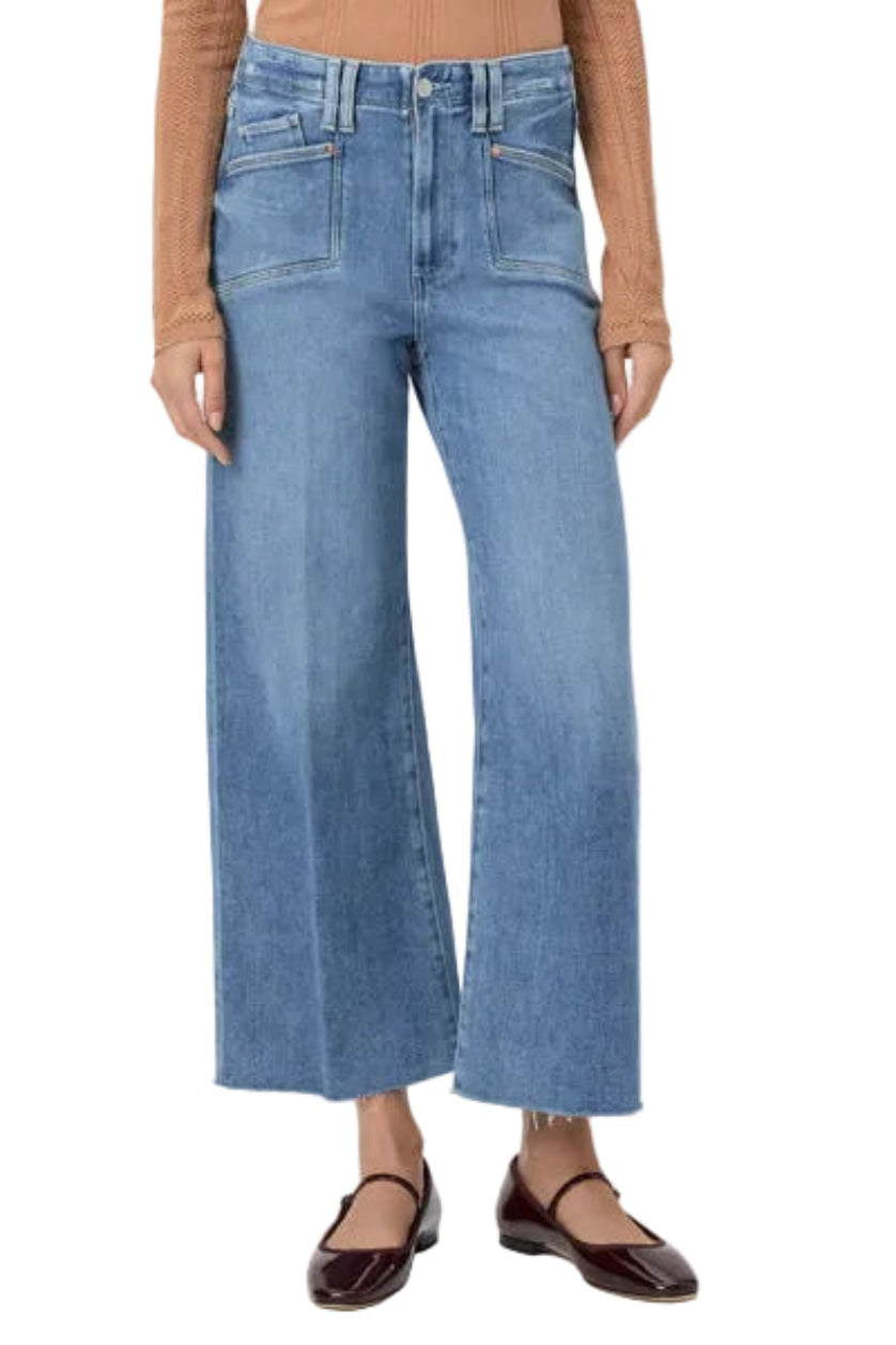 Person wearing blue jeans on a white background.