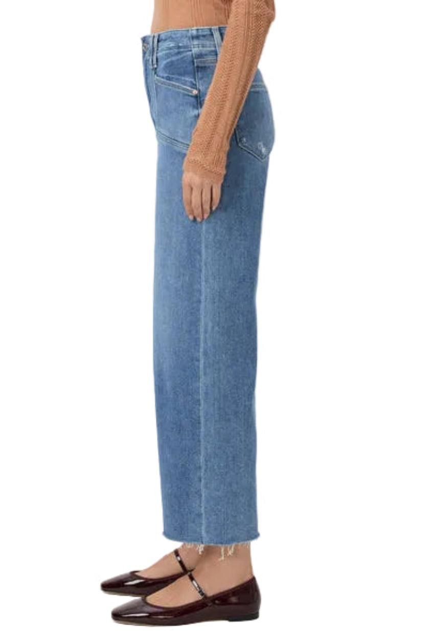Person wearing blue jeans on a white background.