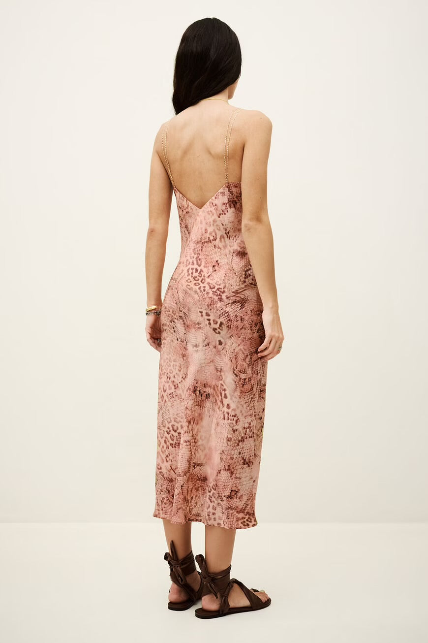 Woman wearing a floral dress with a white background.