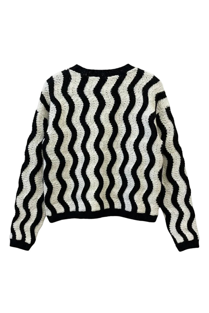 The back of a black and white striped sweater on a white background.