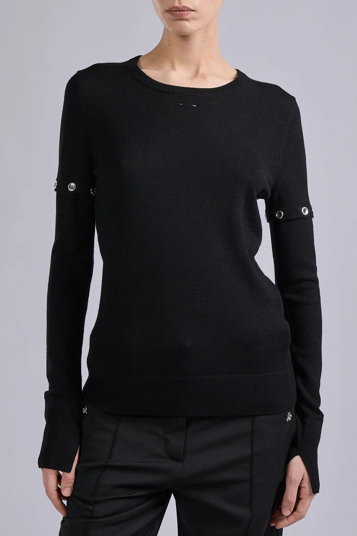 Black long-sleeve top with button details on a gray background