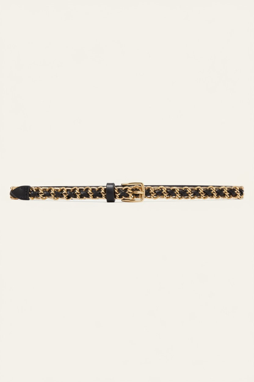 A slim black leather belt with a gold-tone buckle and a repeating gold-tone logo pattern, displayed horizontally on a light cream background.