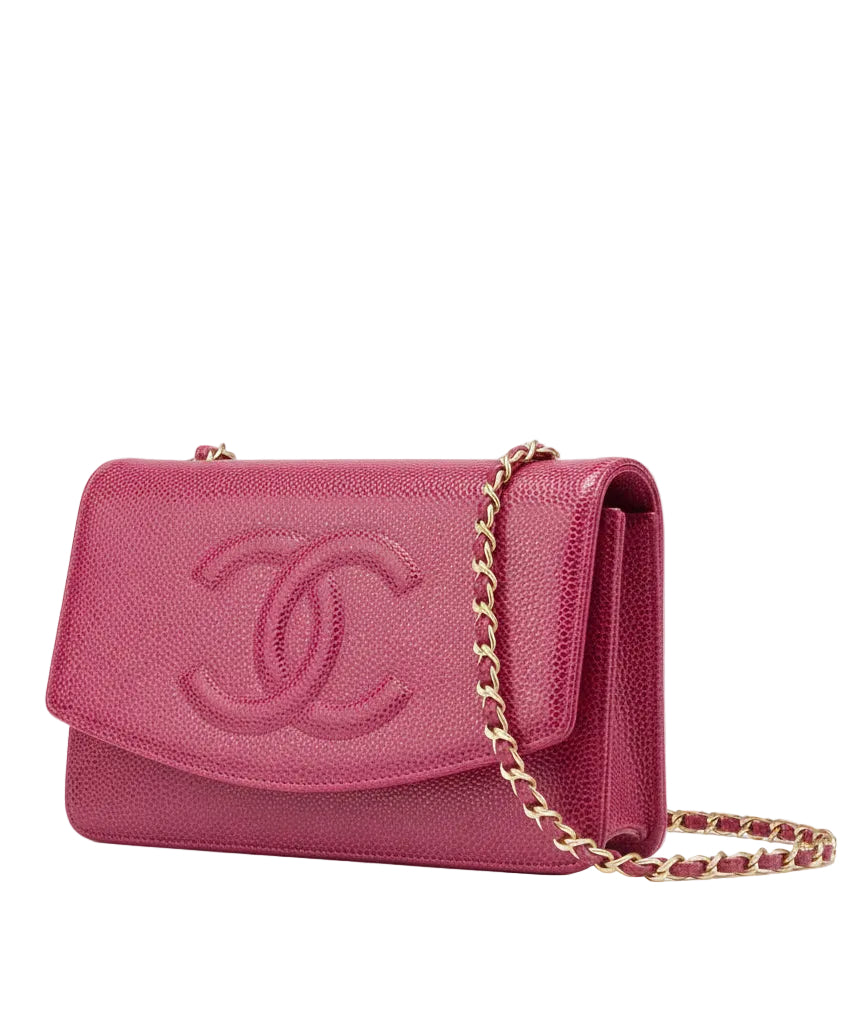 Pink Chanel handbag with gold chain on a white background.