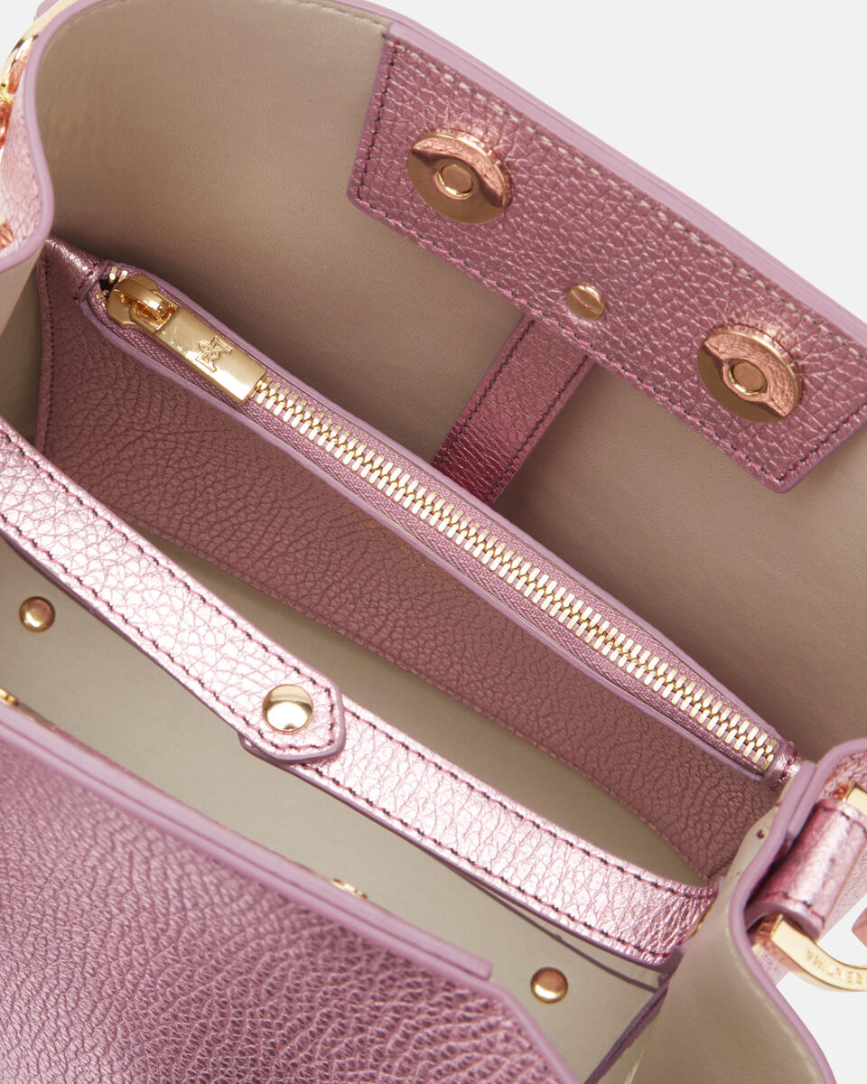 Close-up of a pink handbag with gold accents
