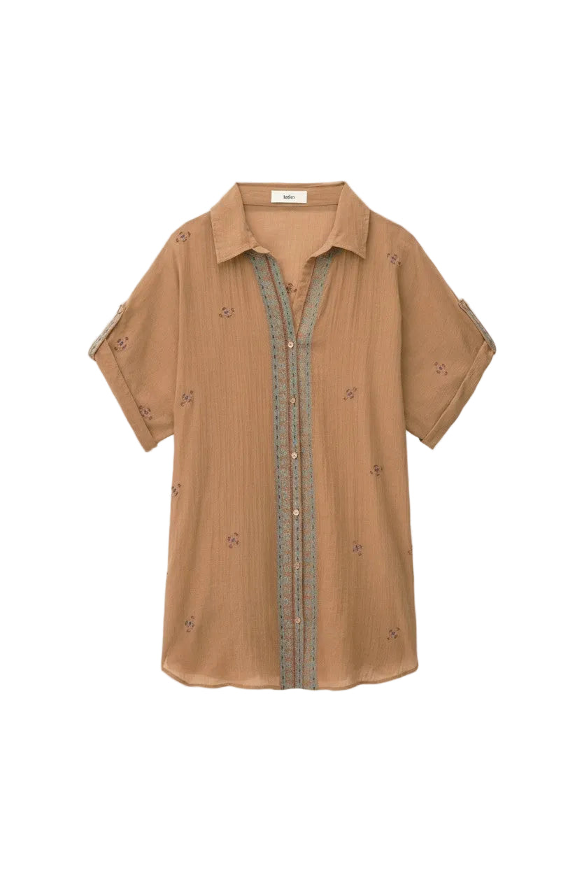 Brown shirt with floral embroidery on a white background.
