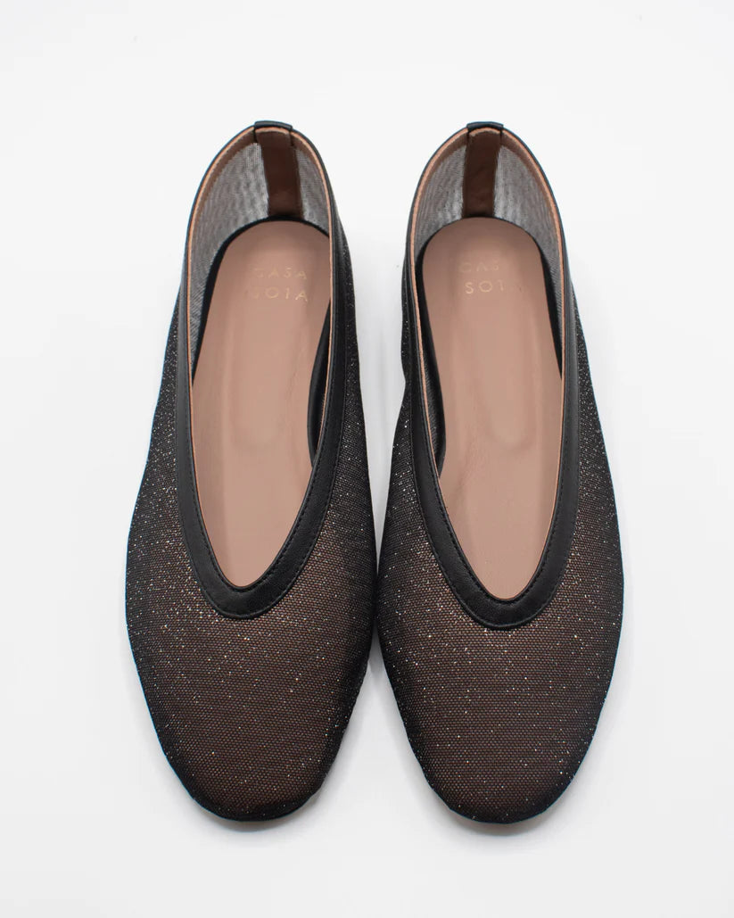 Pair of black mesh shoes on a light background.