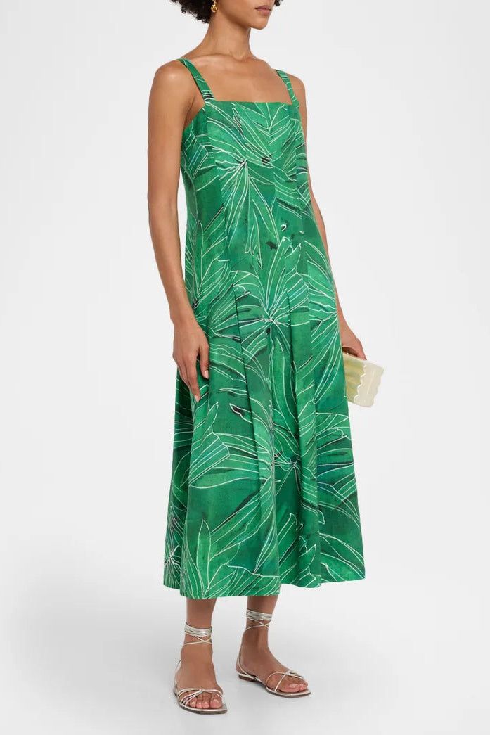 Woman wearing a green leaf-patterned dress on a white background