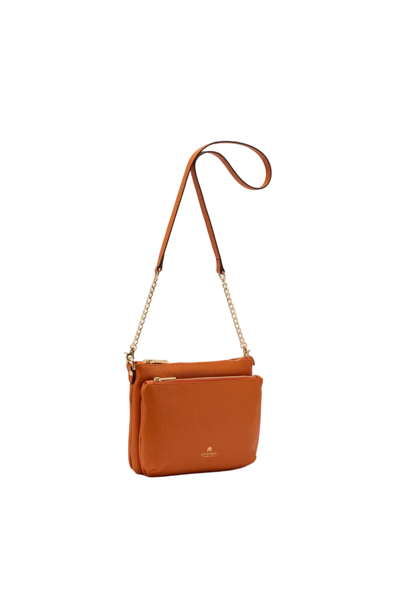 Orange leather crossbody bag on a white background.