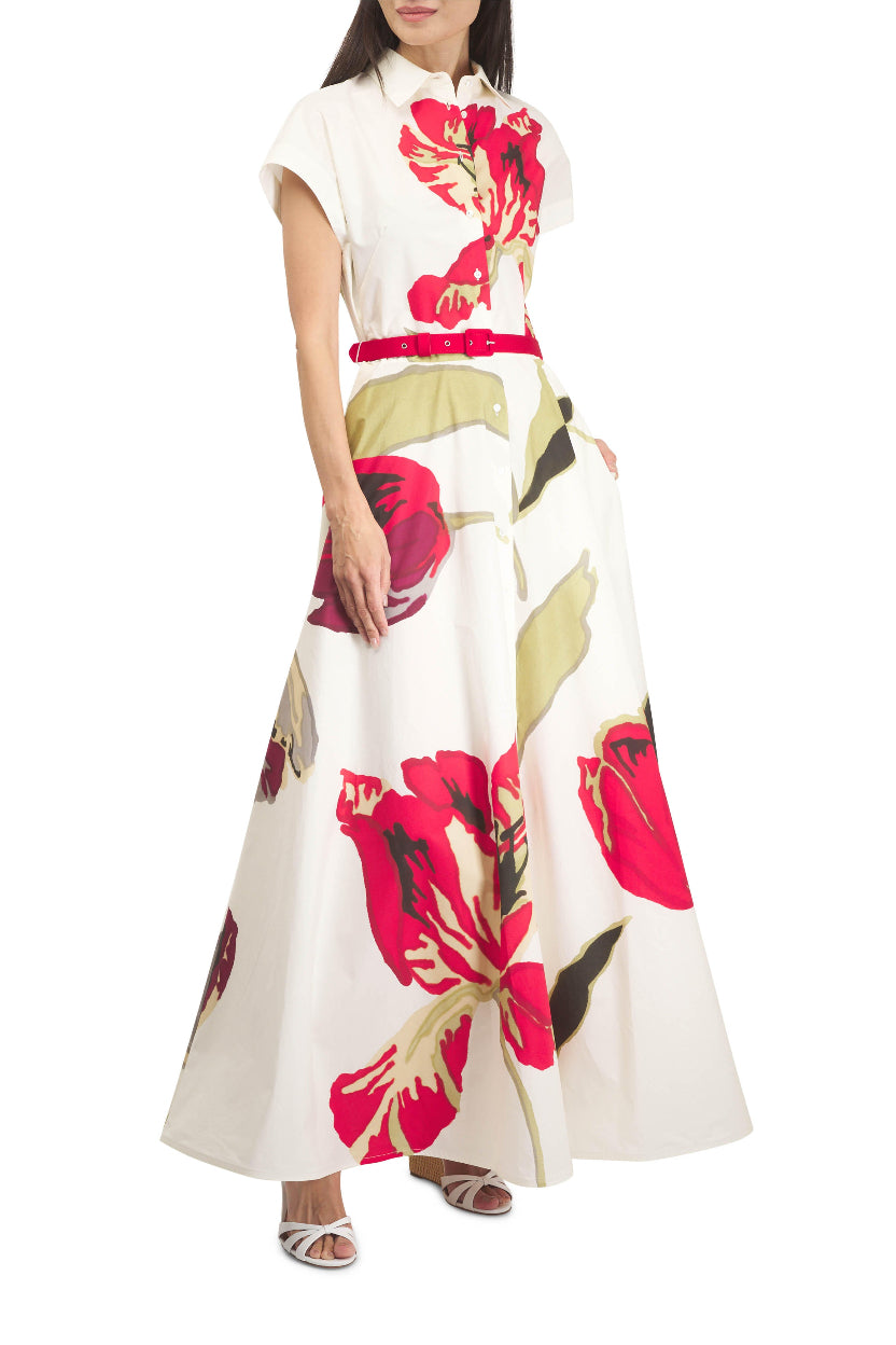 Close-up of a woman wearing a floral dress on a white background.
