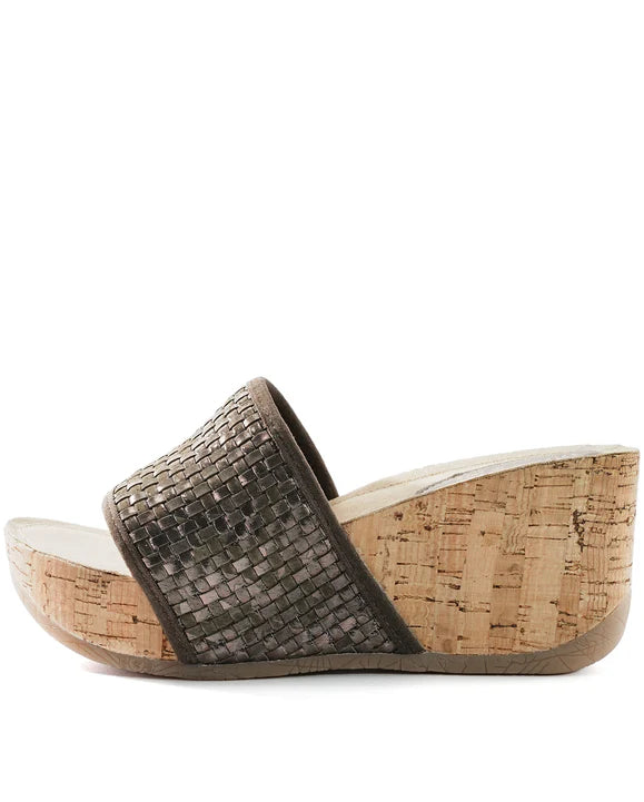 Side view of a woven wedge sandal with cork sole on a white background.