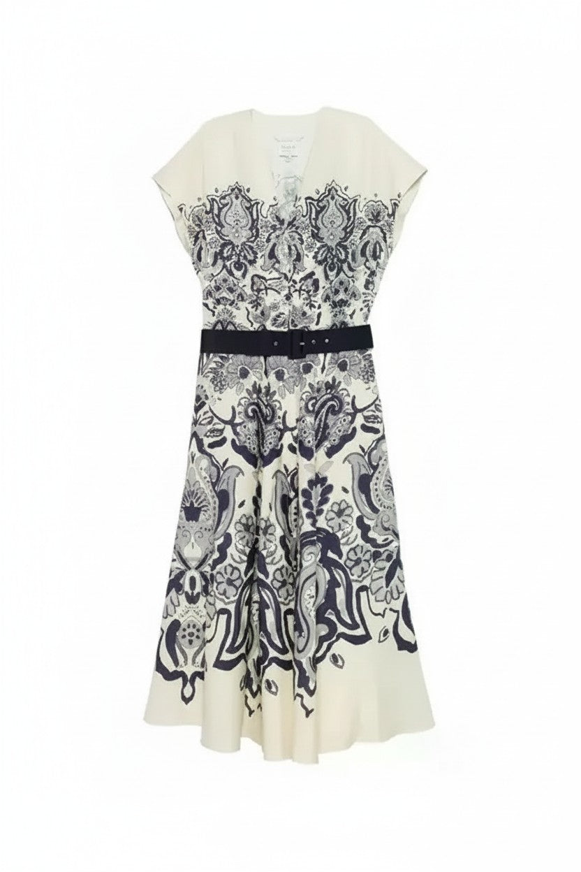 White dress with navy floral pattern on a white background.