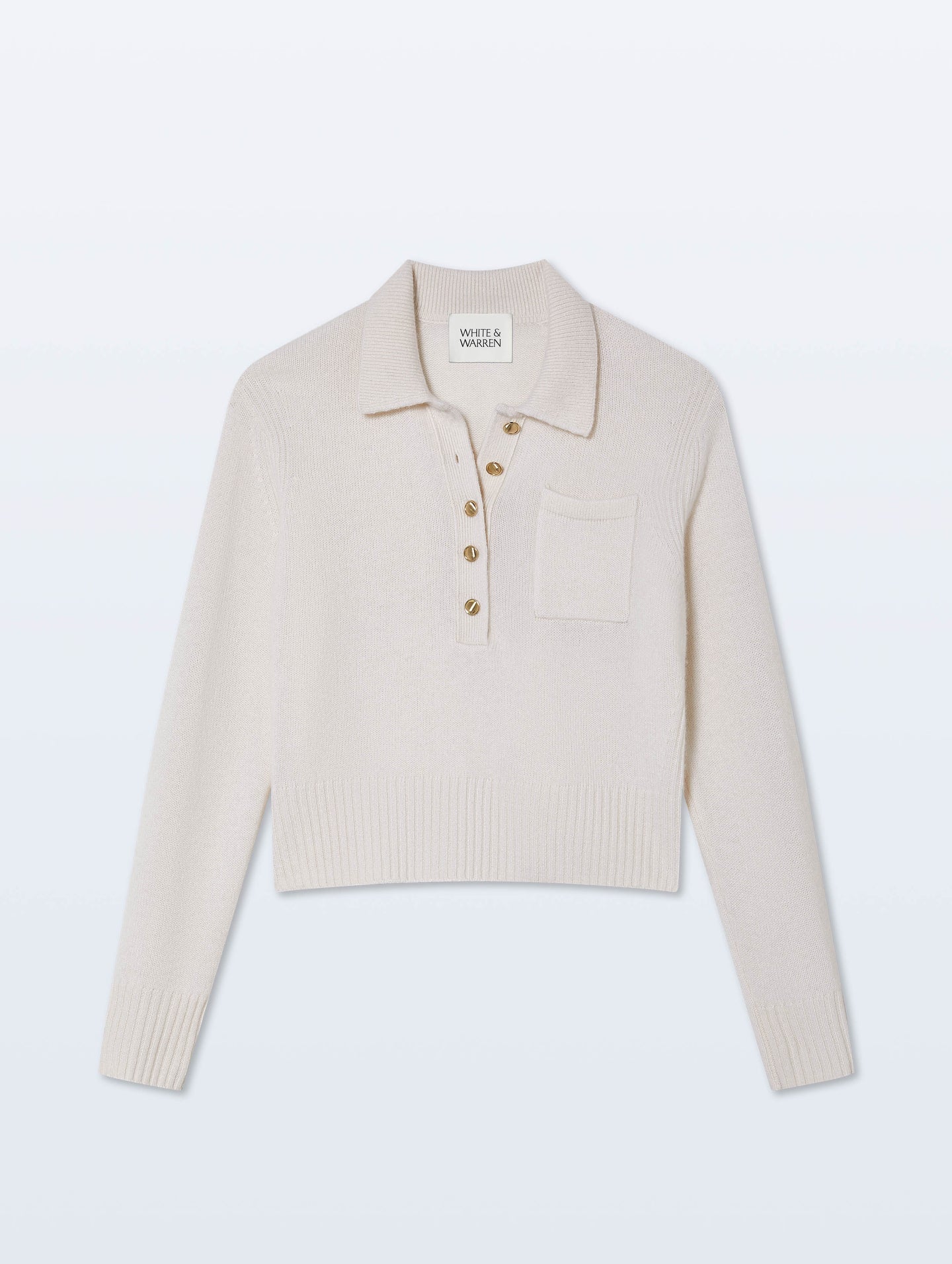 Beige knit polo shirt with gold buttons on a light gray background.