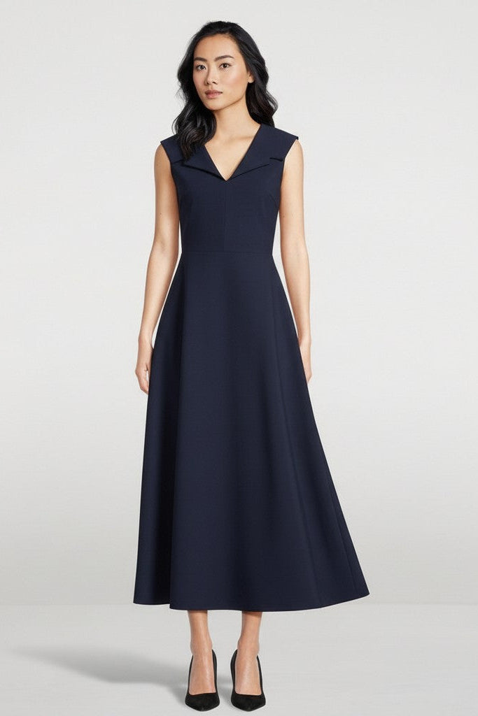 Woman wearing a navy blue dress on a white background.