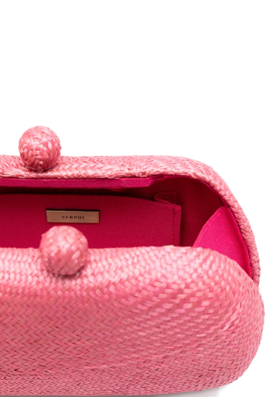 Pink textured clutch bag with a visible brand label on a white background.