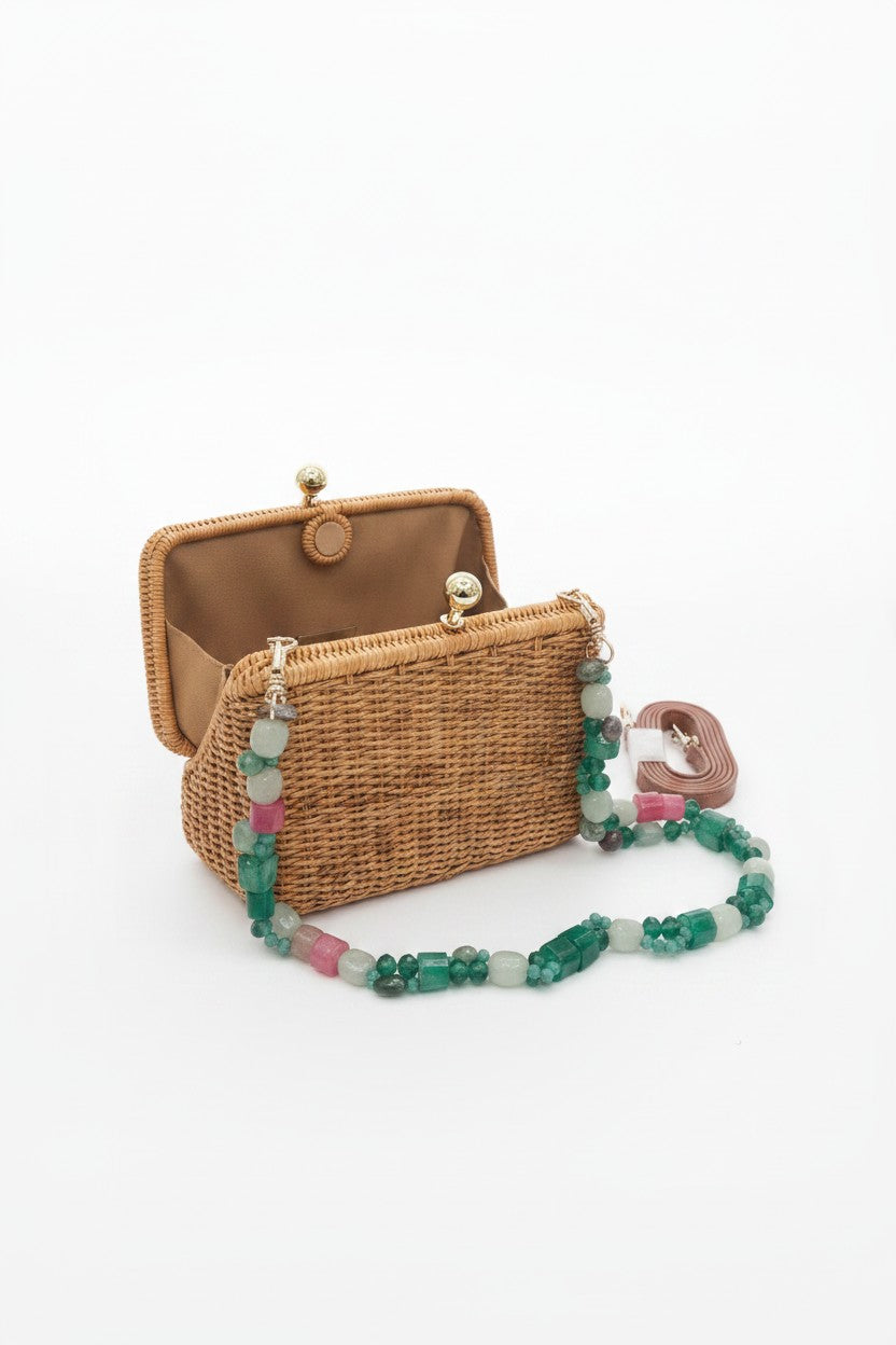 Wicker handbag with a colorful beaded strap on a white background.