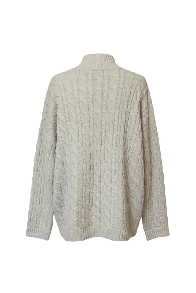 The back of an ivory cable knit sweater on a white background.