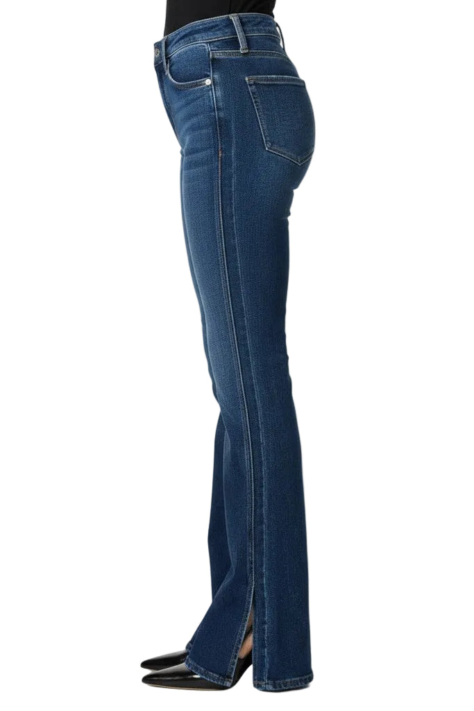 Side angle of a woman wearing jeans on a white background.