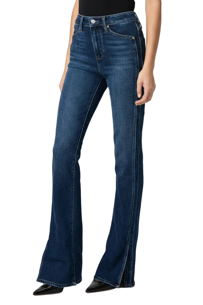 Blue flared jeans worn by a woman on a white background