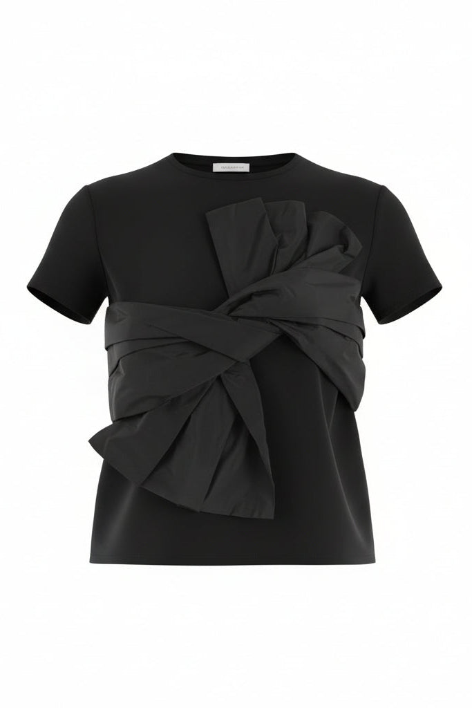 Black top with a large bow detail on a white background.