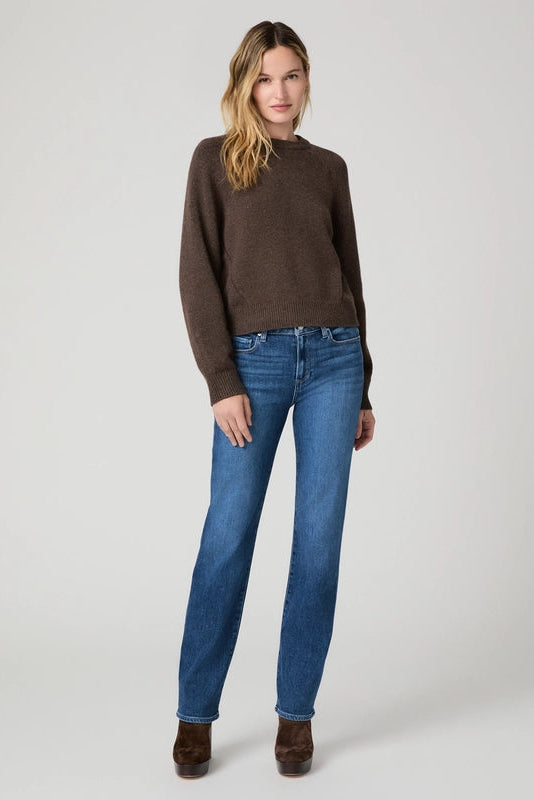Model wearing PAIGE Mason straight-leg jeans in the Antica wash with a brown sweater and platform boots.