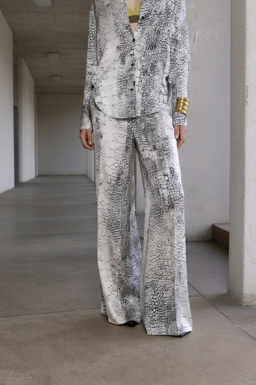 Close-up of a woman wearing a patterned suit in an indoor setting.