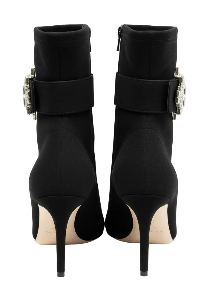 Black high-heeled boots with buckle details on a white background.
