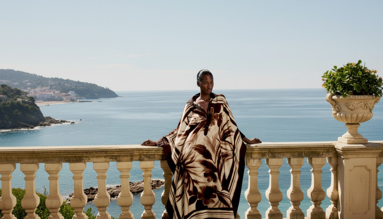 Woman standing on a balcony with a scenic ocean view.