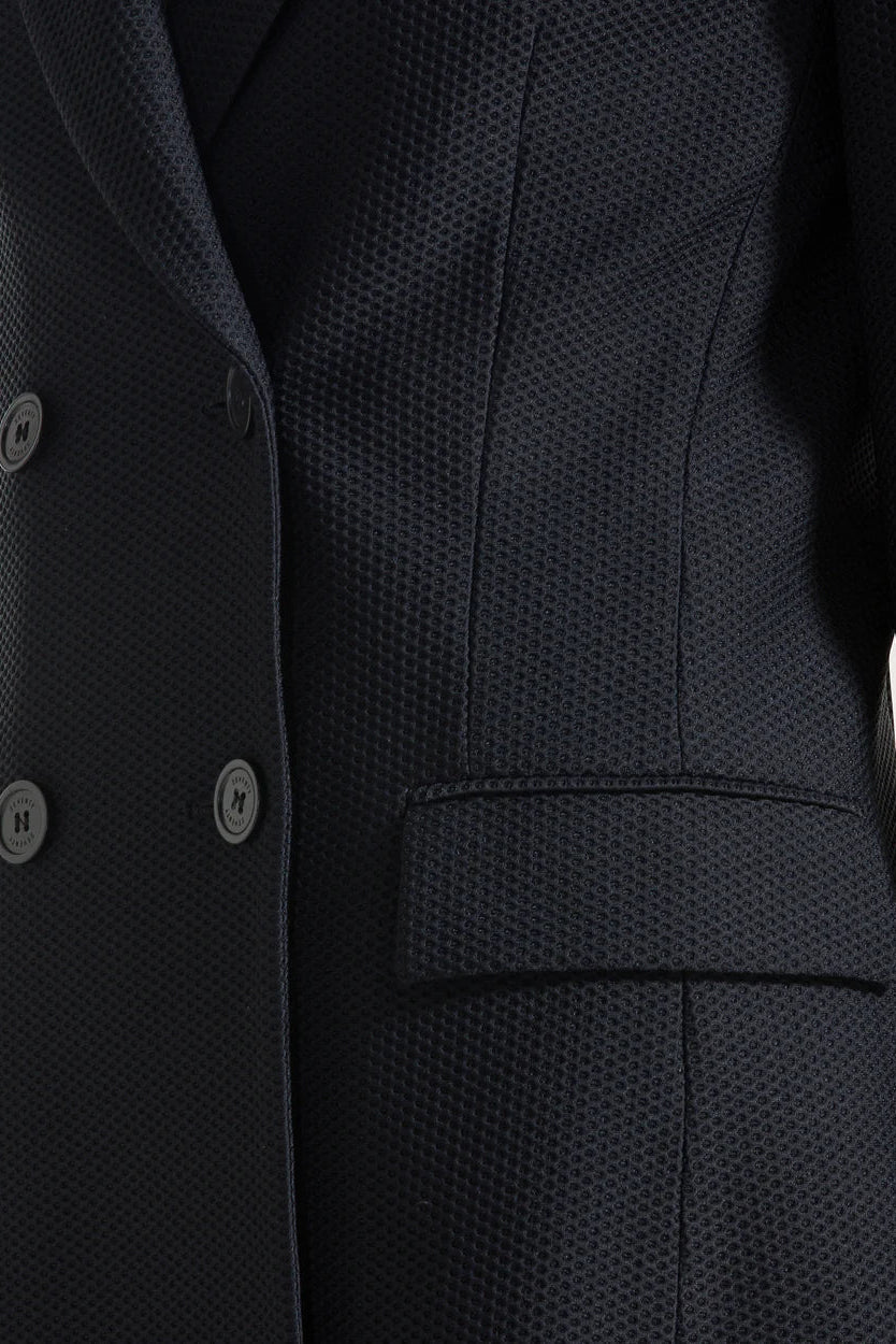 Close-up of a black textured suit jacket with buttons.