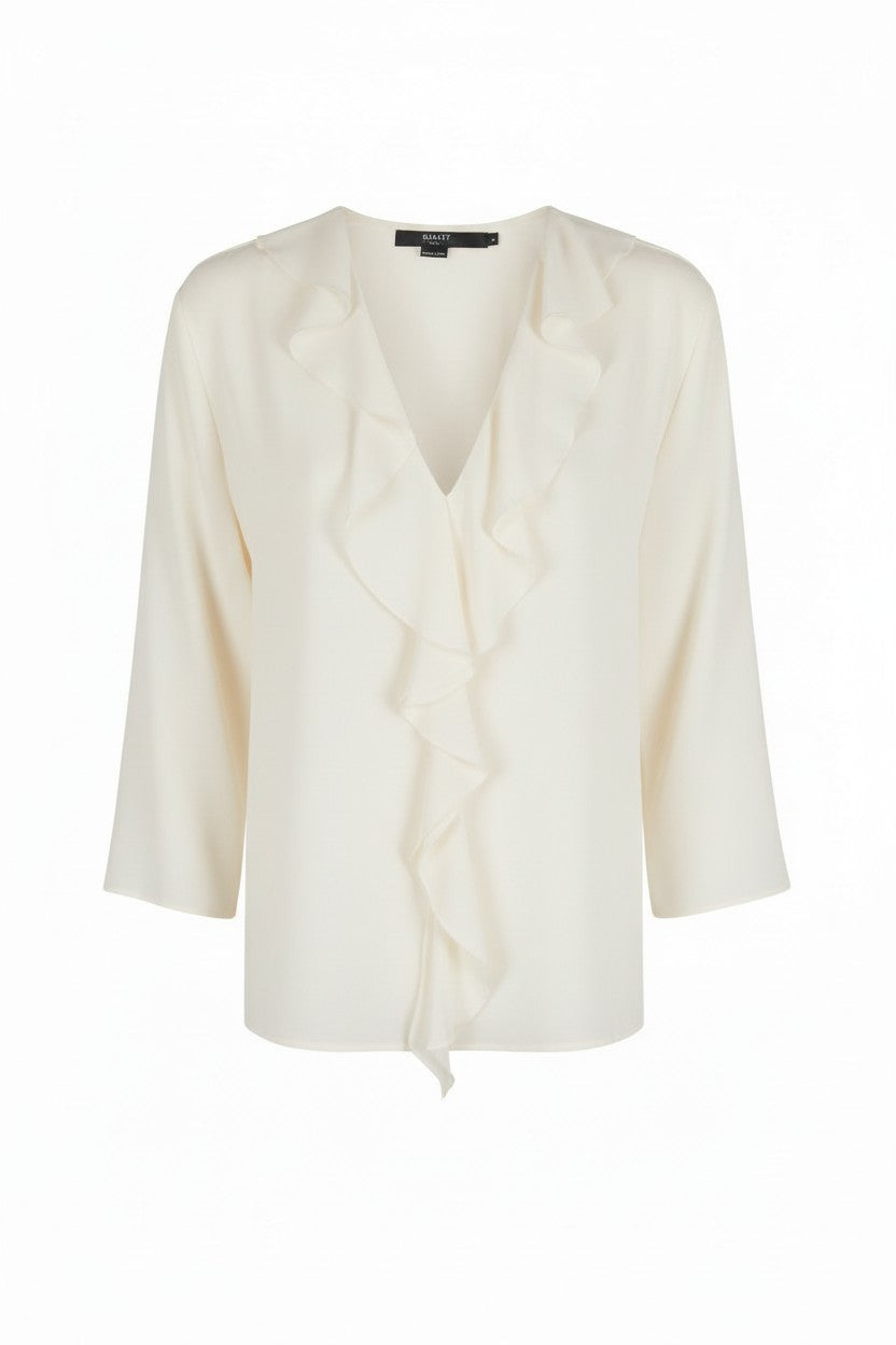 White blouse with a ruffle v-neckline on a white background.