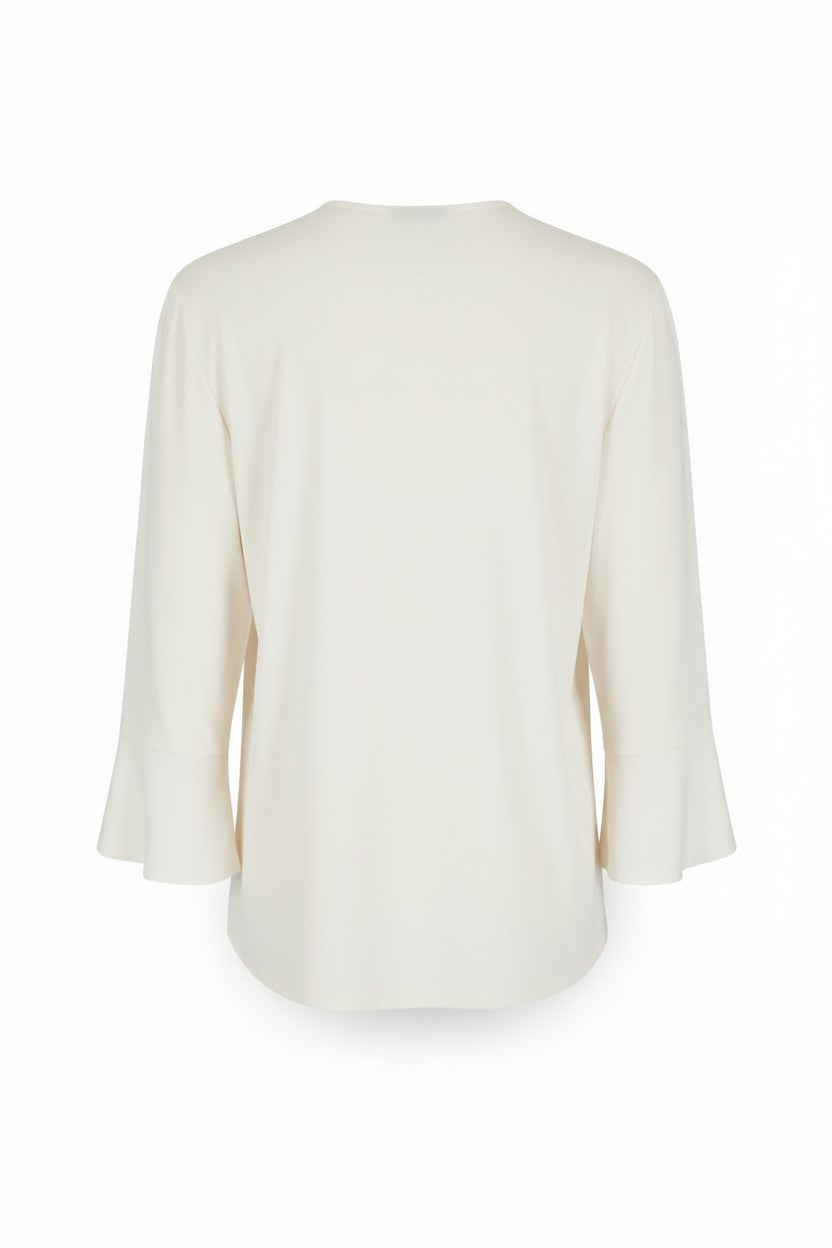 The back of an off-white blouse on a white background.