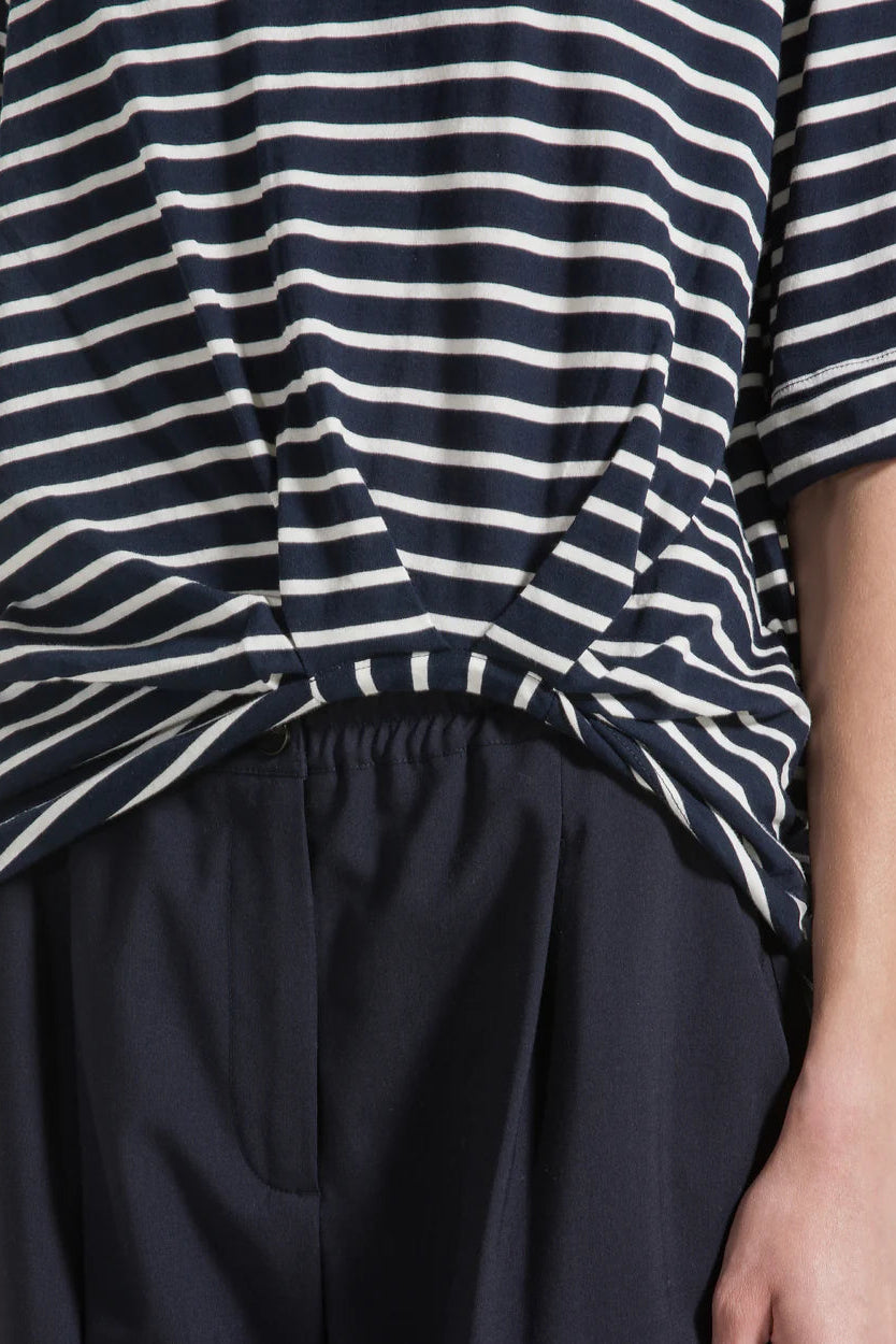Close-up of a navy and white striped shirt with a plain background.