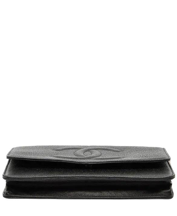 Bottom of a black clutch bag with a brand logo on a white background.