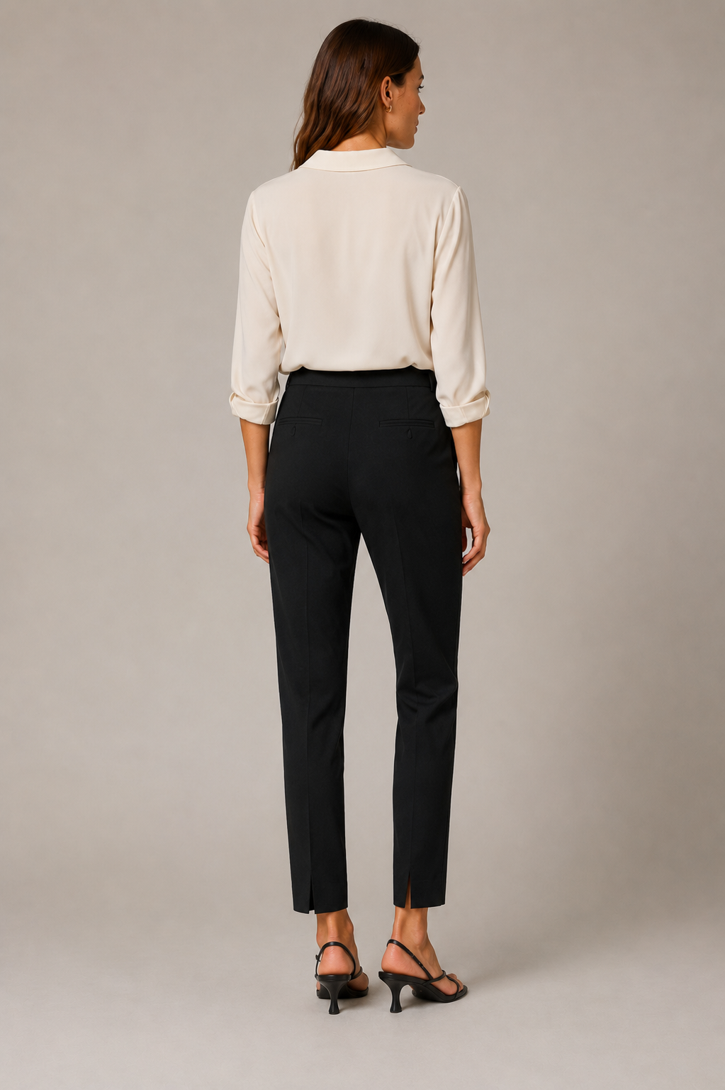 Model wearing the black Peserico Bi-Stretch Canvas Pant from the back, showing the small back hem slits.