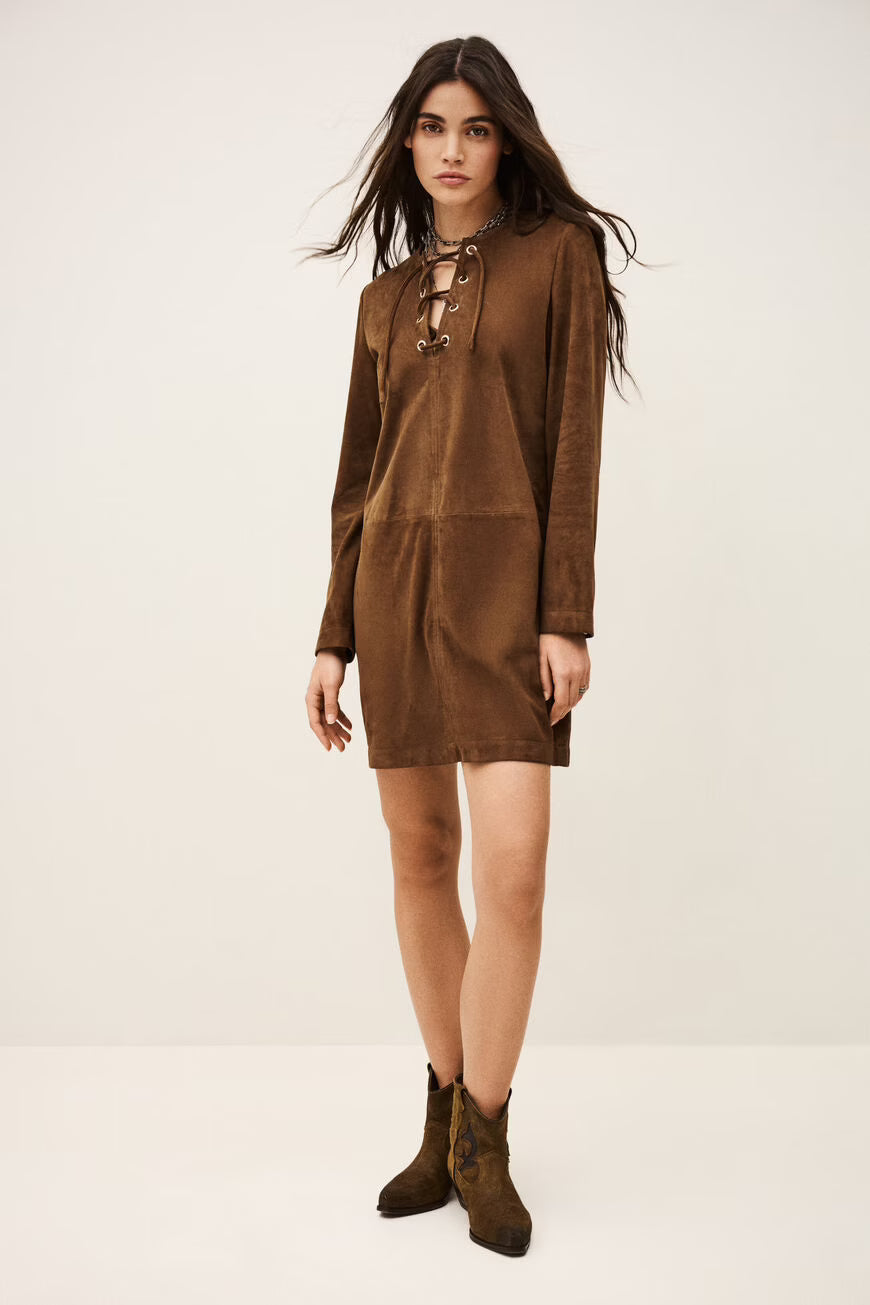 Woman wearing a brown dress with long sleeves on a white background