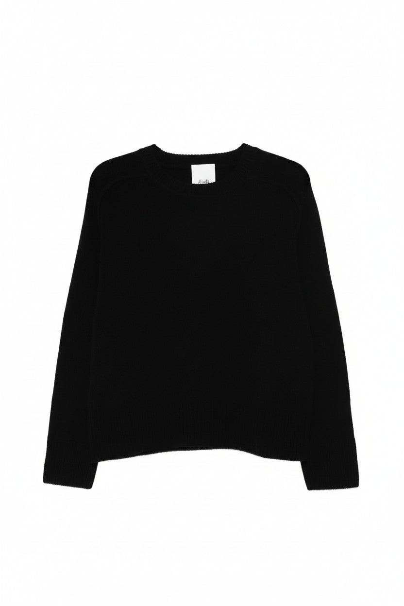 Black crewneck sweater on a white background.