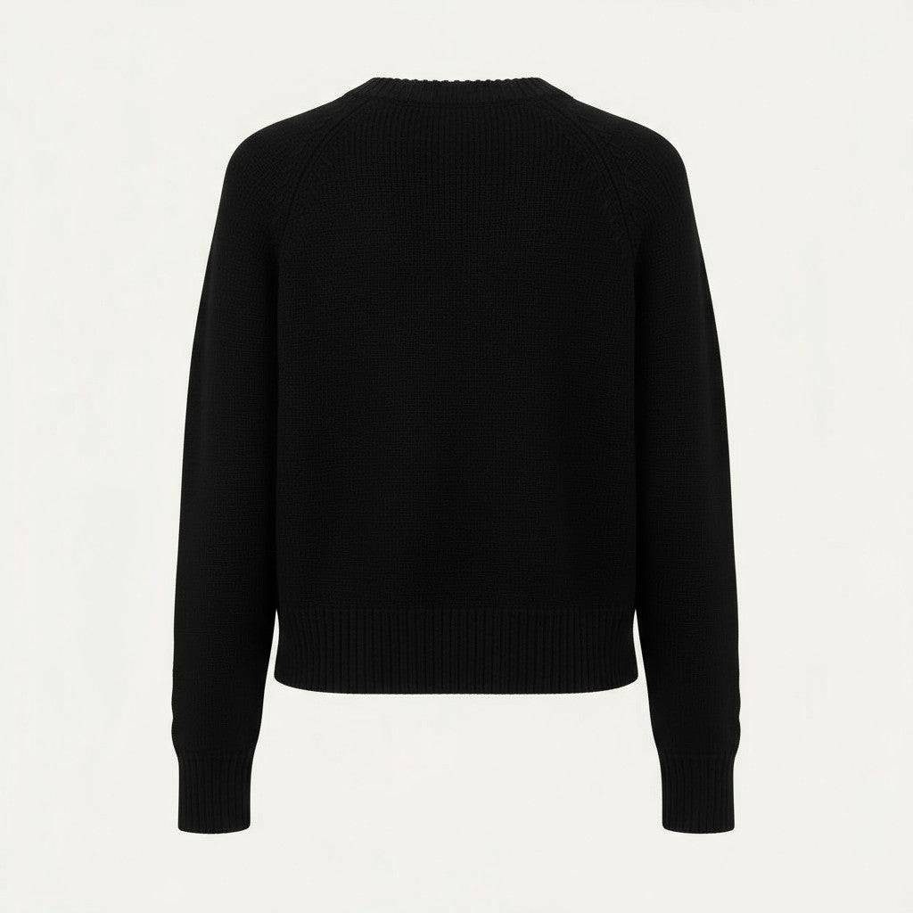 Back of a black sweater on a light gray background.