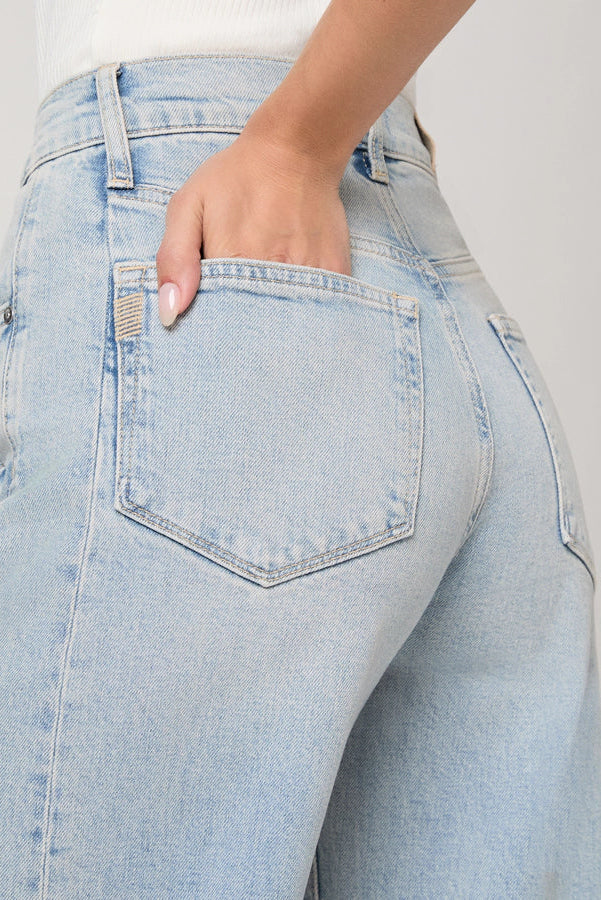 Light blue jeans with a pocket detail on a plain background.