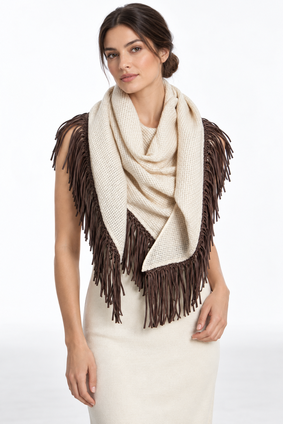 Female model wearing an ivory woven triangular Bajra scarf with dark chocolate braided trim and fringe, styled with a pale blouse and brown trousers.