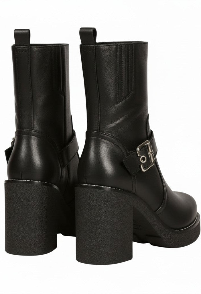 Black leather boots with chunky heels on a white background.