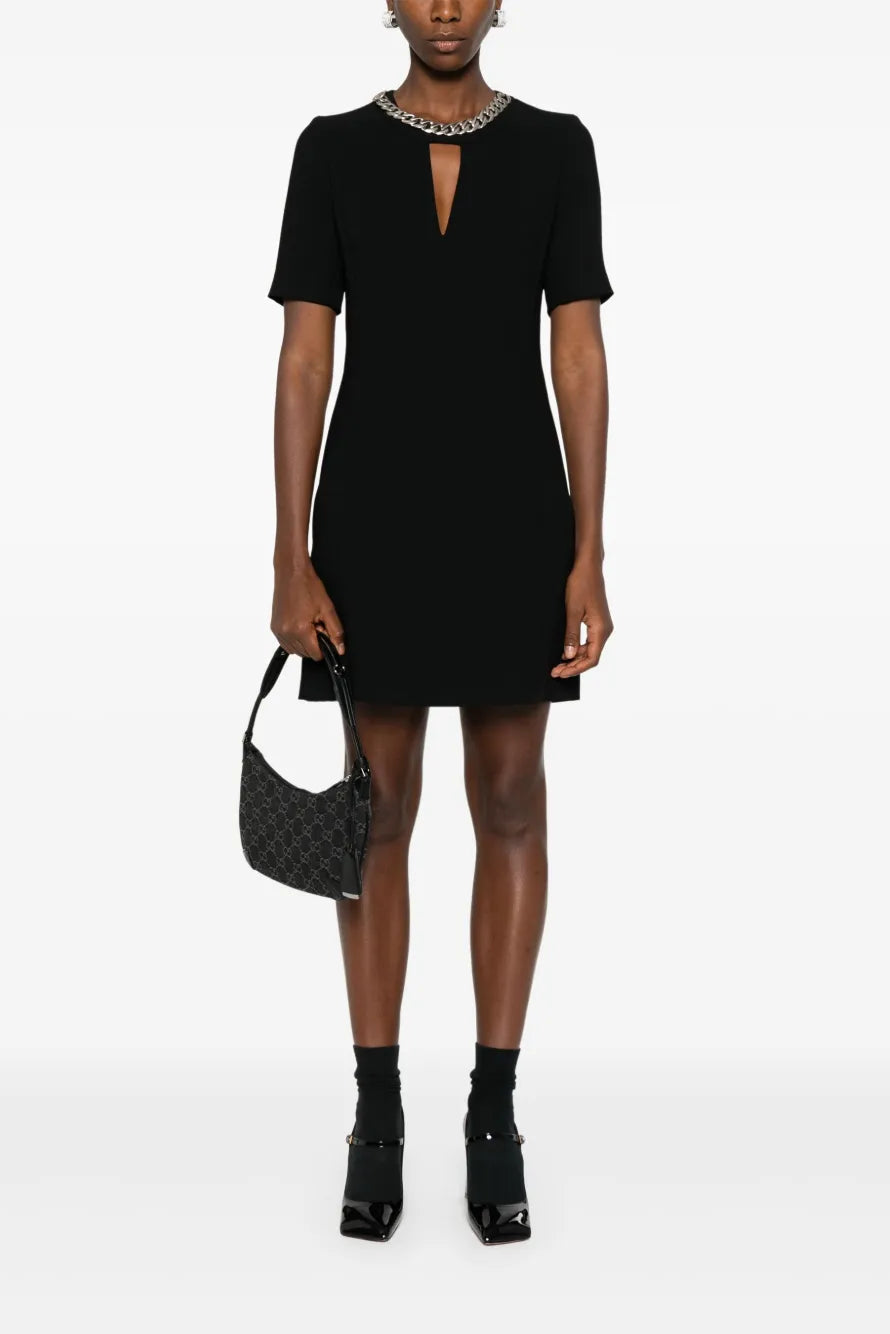 Person wearing a black dress with a white background