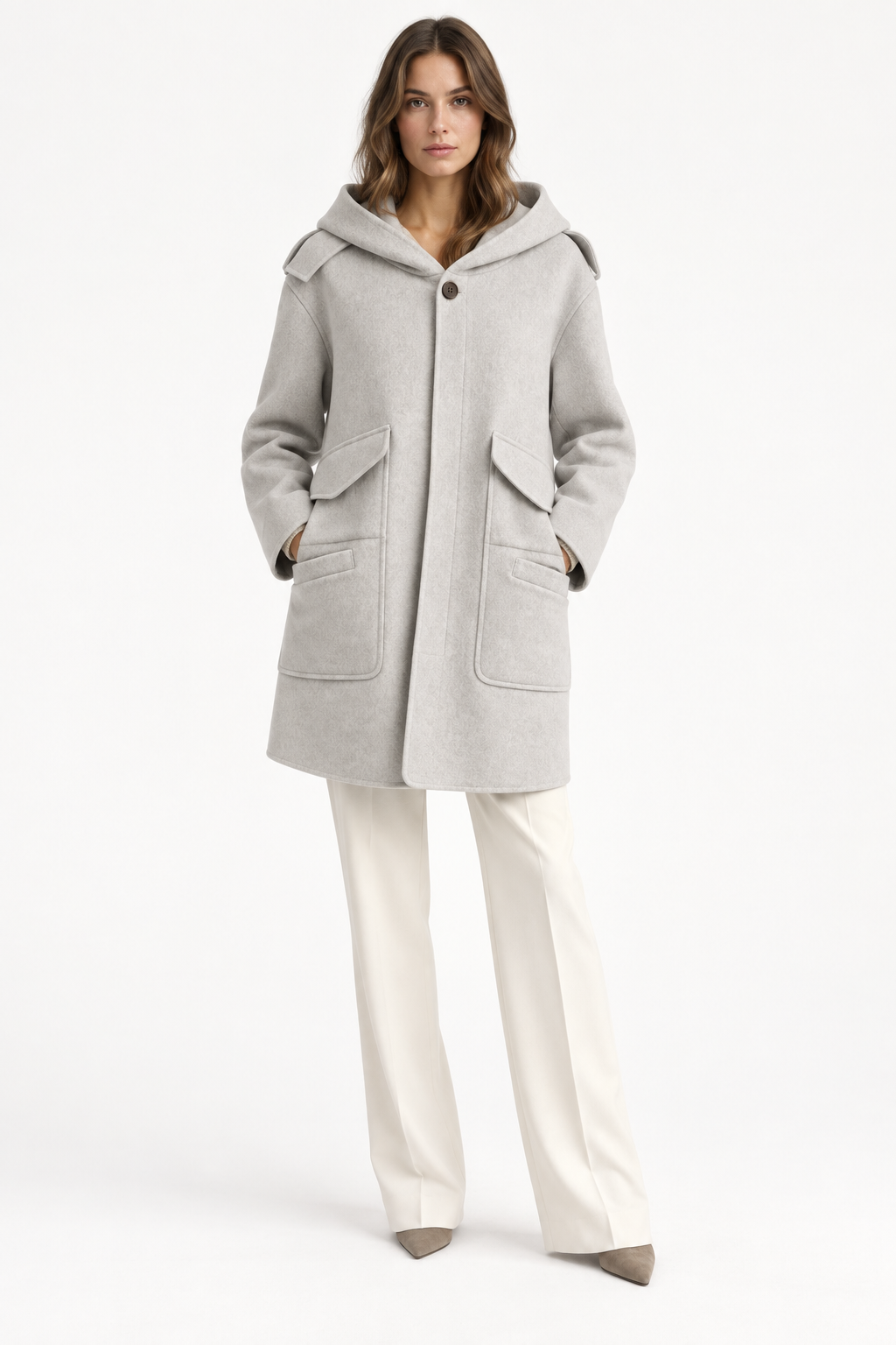 Model wearing a light gray Barbara Bui hooded wool and cashmere coat with cream trousers, front view.