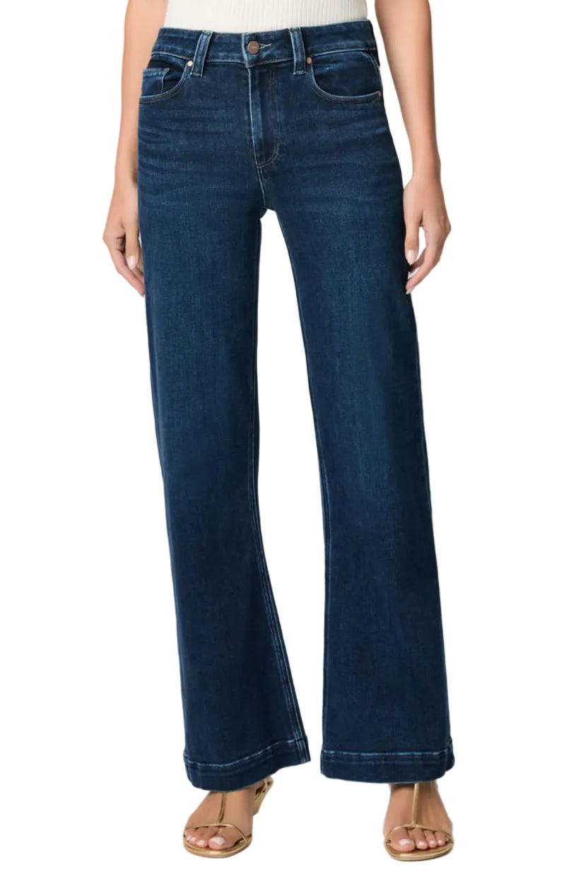 Blue jeans worn by a person on a white background.