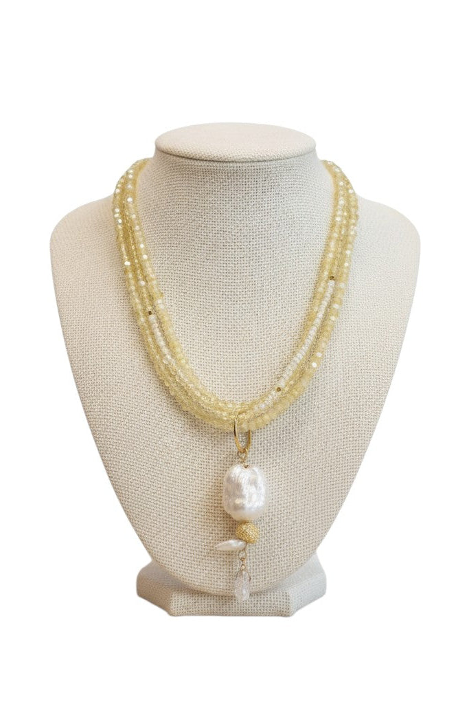 Layerd pearl necklace on a mannequin bust against a white background.