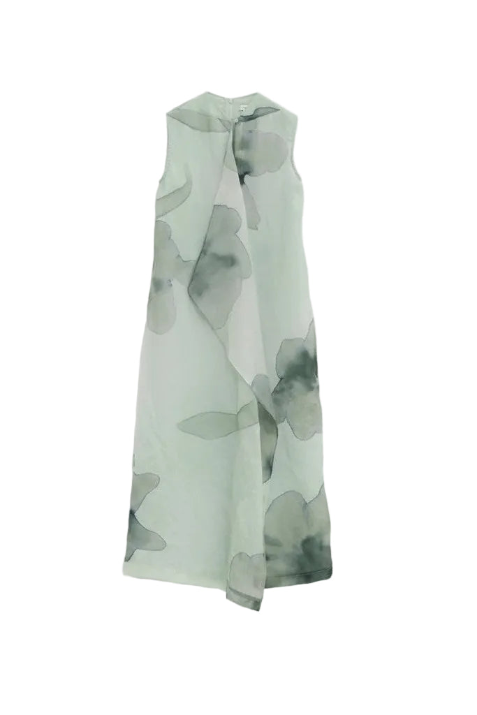 Back of a green floral patterned dress on a white background.