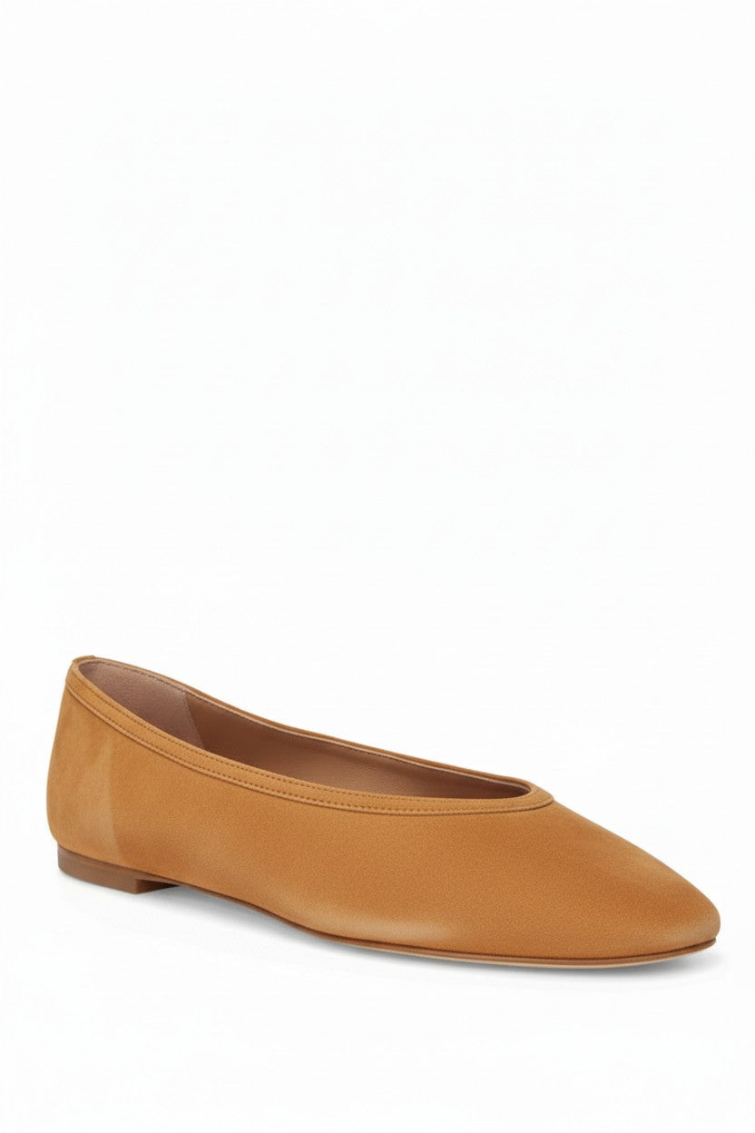 Burnt suede flat shoe on a white background.