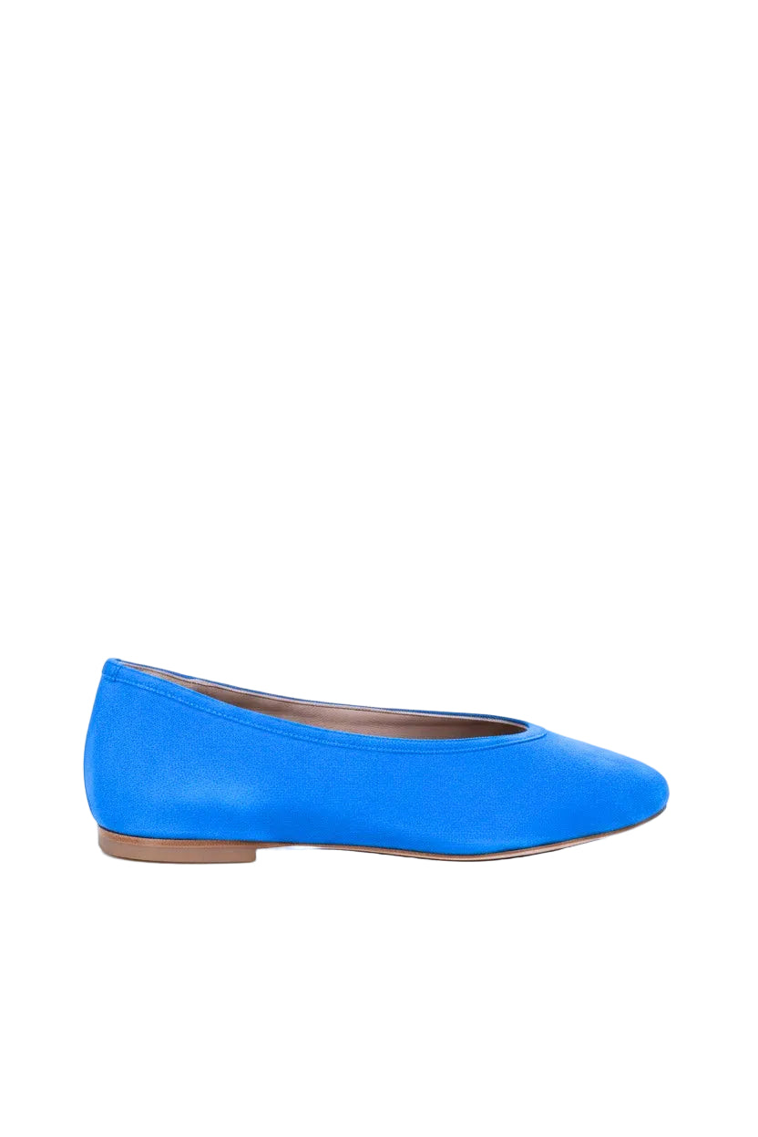 Blue suede flat shoe on a white background.