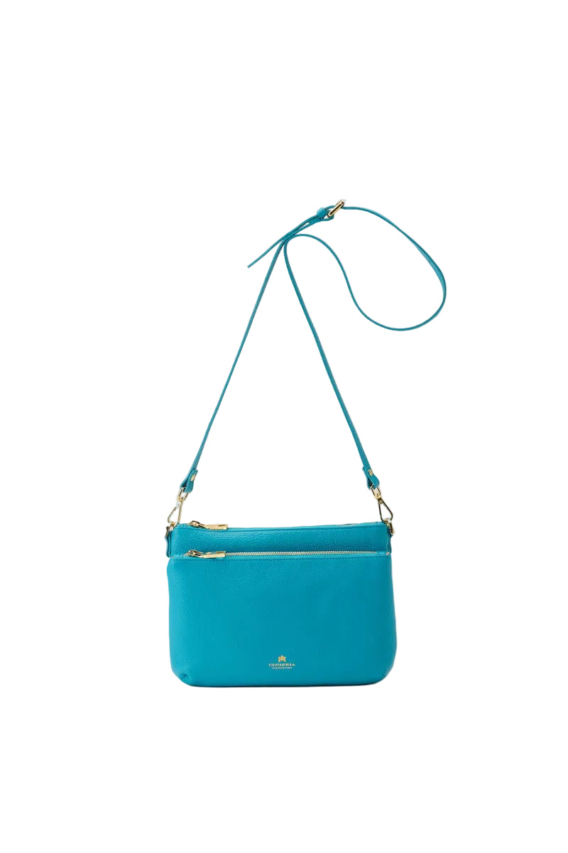 Blue crossbody bag with a strap on a white background