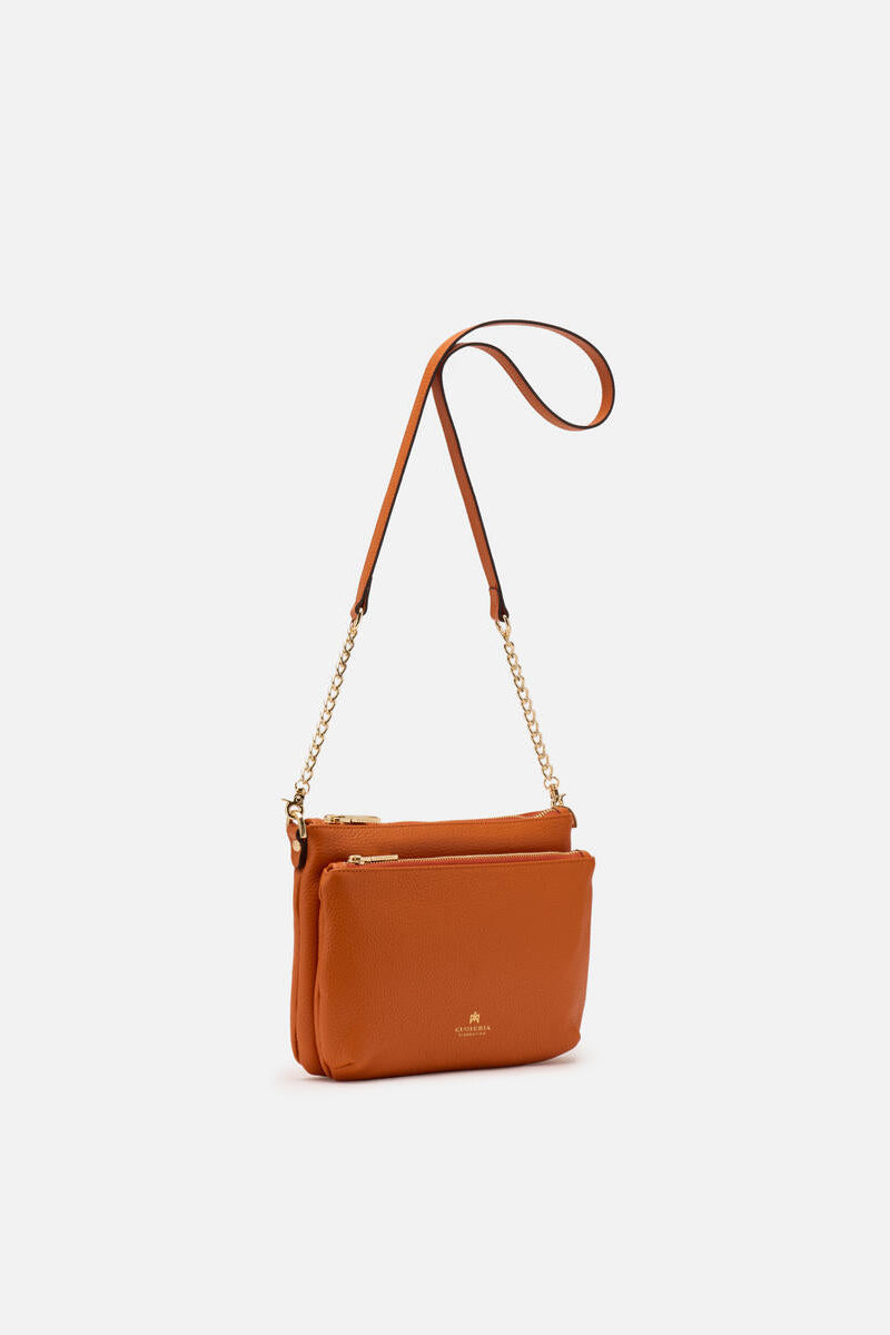 Orange leather crossbody bag on a white background.