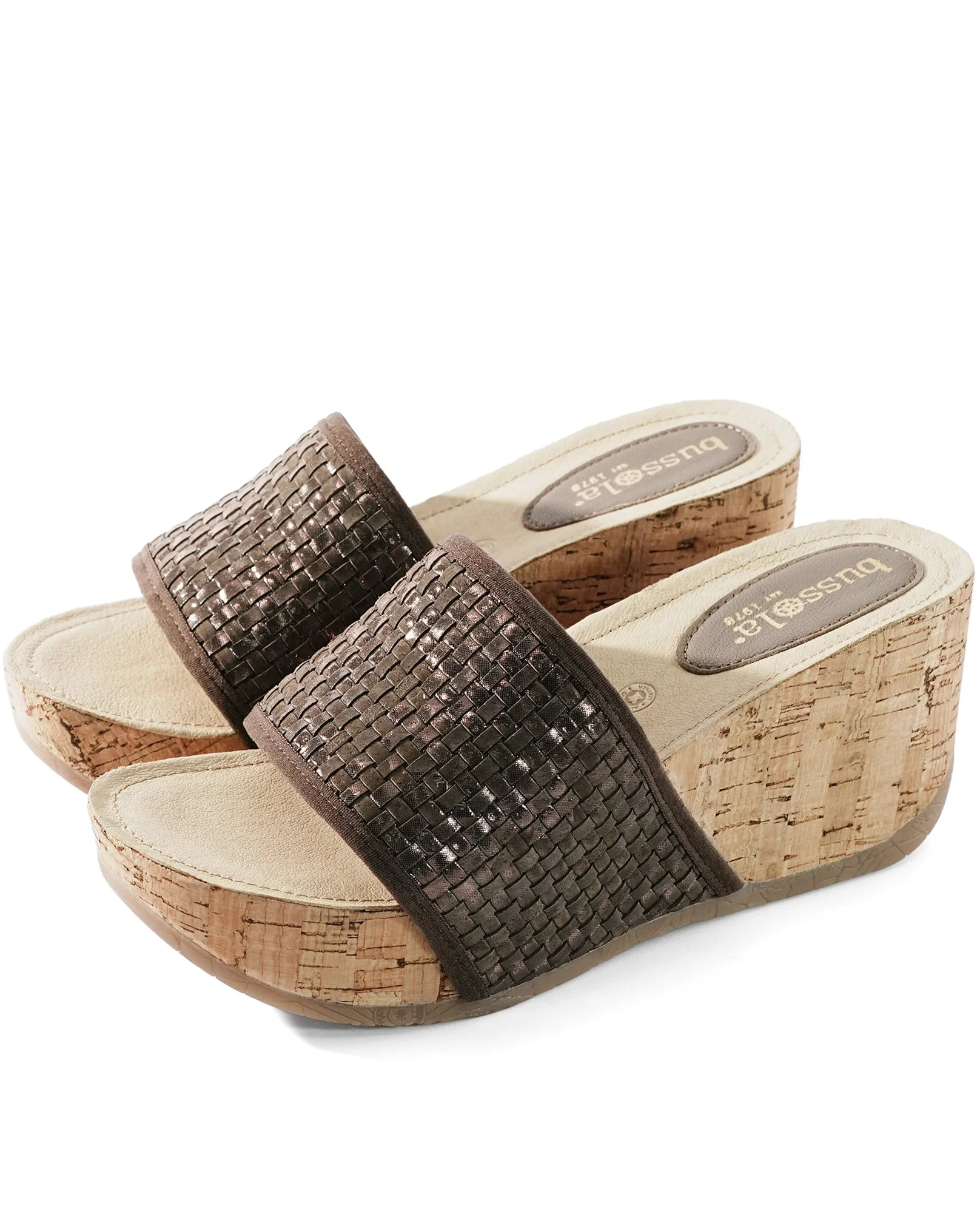 Brown wedge sandals with cork sole on a white background.