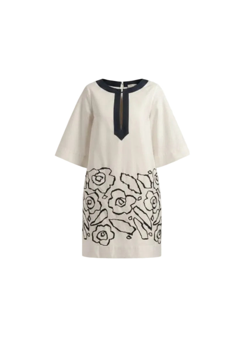 Off-whitr dress with navy floral patterns on a white background.